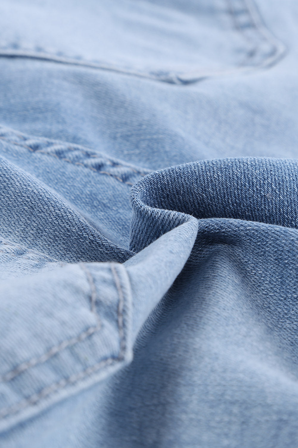 A pair of dark blue frayed hem denim shorts displayed on a white background, showcasing the stylish distressed design and pockets.