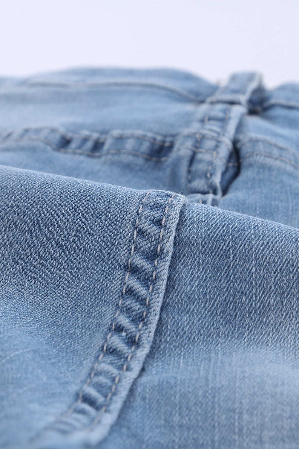 A pair of dark blue frayed hem denim shorts displayed on a white background, showcasing the stylish distressed design and pockets.