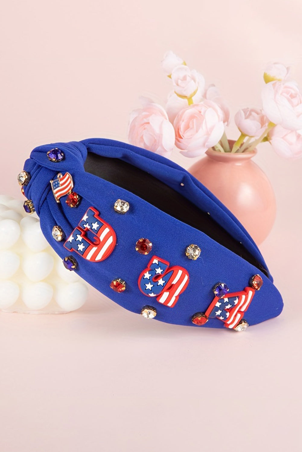 Dark blue wide headband featuring USA flag design and gemstone decor, knotted style for a trendy look.