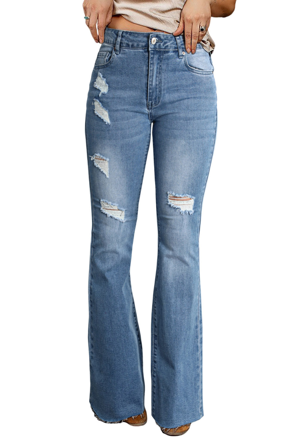 A pair of dark wash mid rise flare jeans featuring a trendy ripped design and raw hem detail, perfect for stylish casual wear.