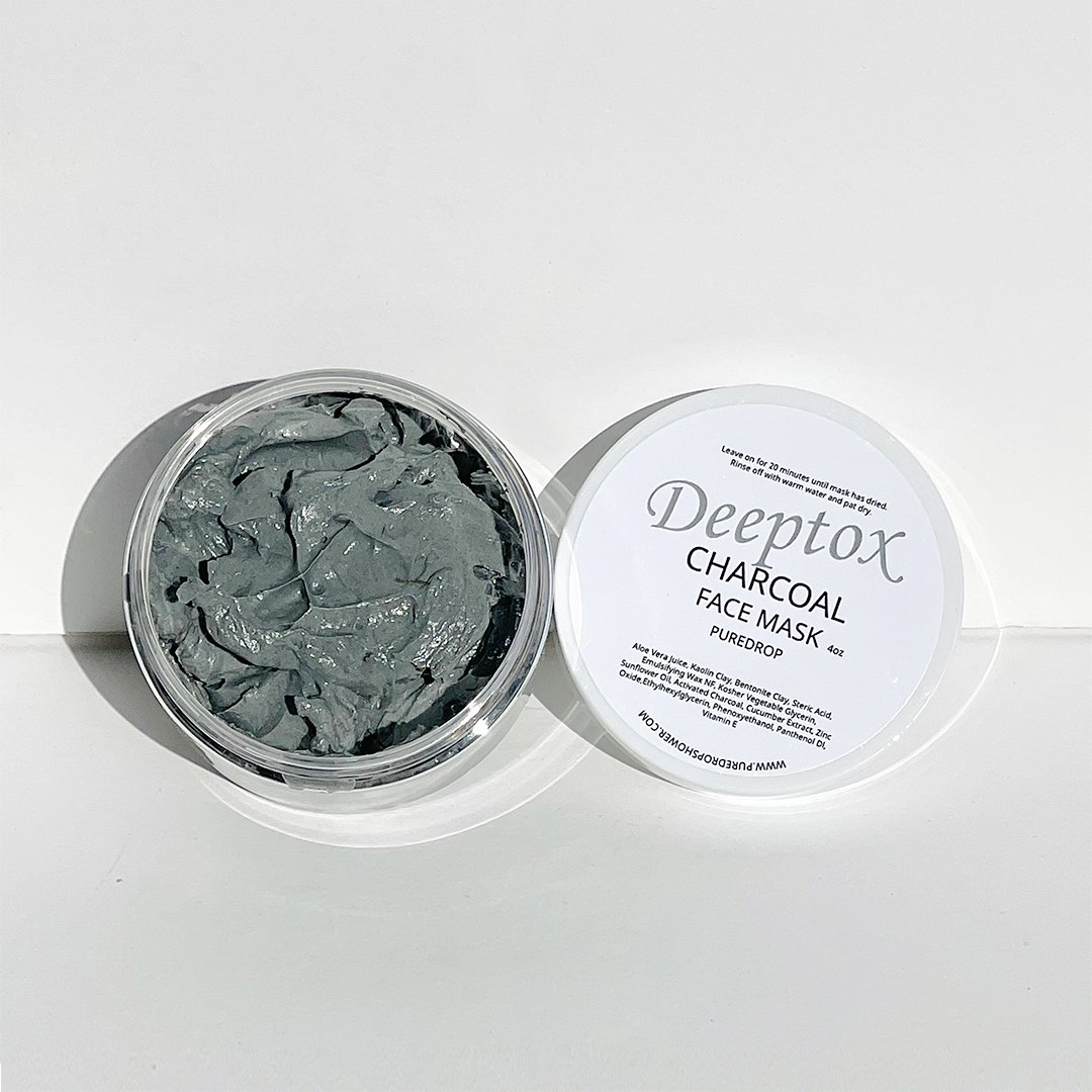 Deeptox Activated Charcoal Facial Mask in a sleek container, showcasing its rich, dark gel texture surrounded by natural ingredients.