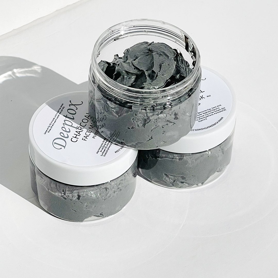 Deeptox Activated Charcoal Facial Mask in a sleek container, showcasing its rich, dark gel texture surrounded by natural ingredients.