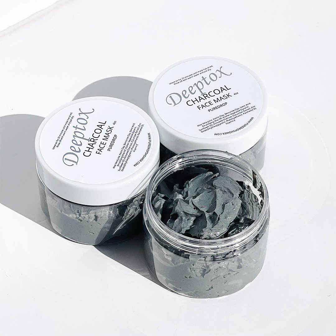 Deeptox Activated Charcoal Facial Mask in a sleek container, showcasing its rich, dark gel texture surrounded by natural ingredients.