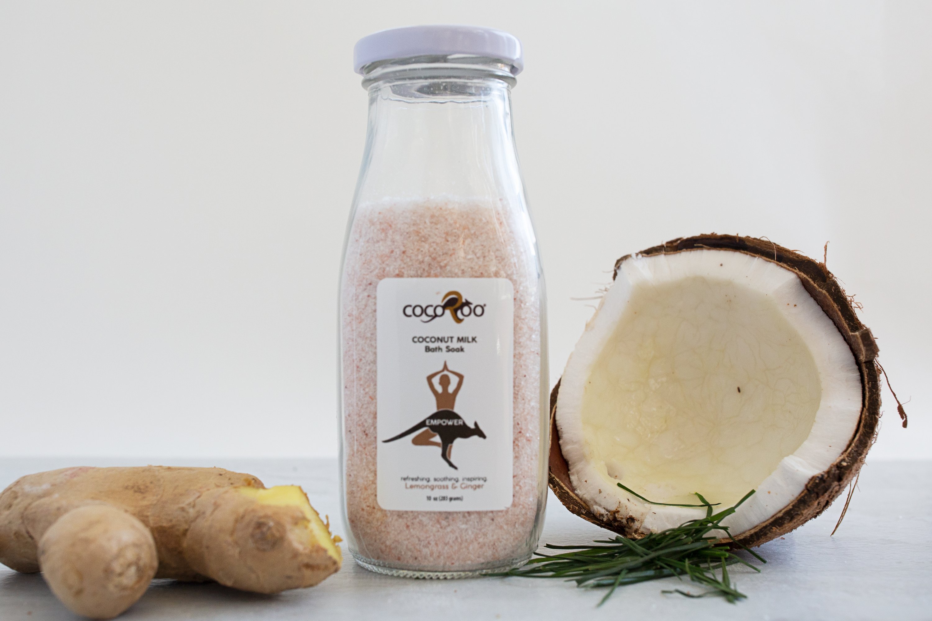 EMPOWER Coconut Milk Bath Soak in a stylish jar, showcasing its natural ingredients like Pink Himalayan Salt and coconut milk powder.