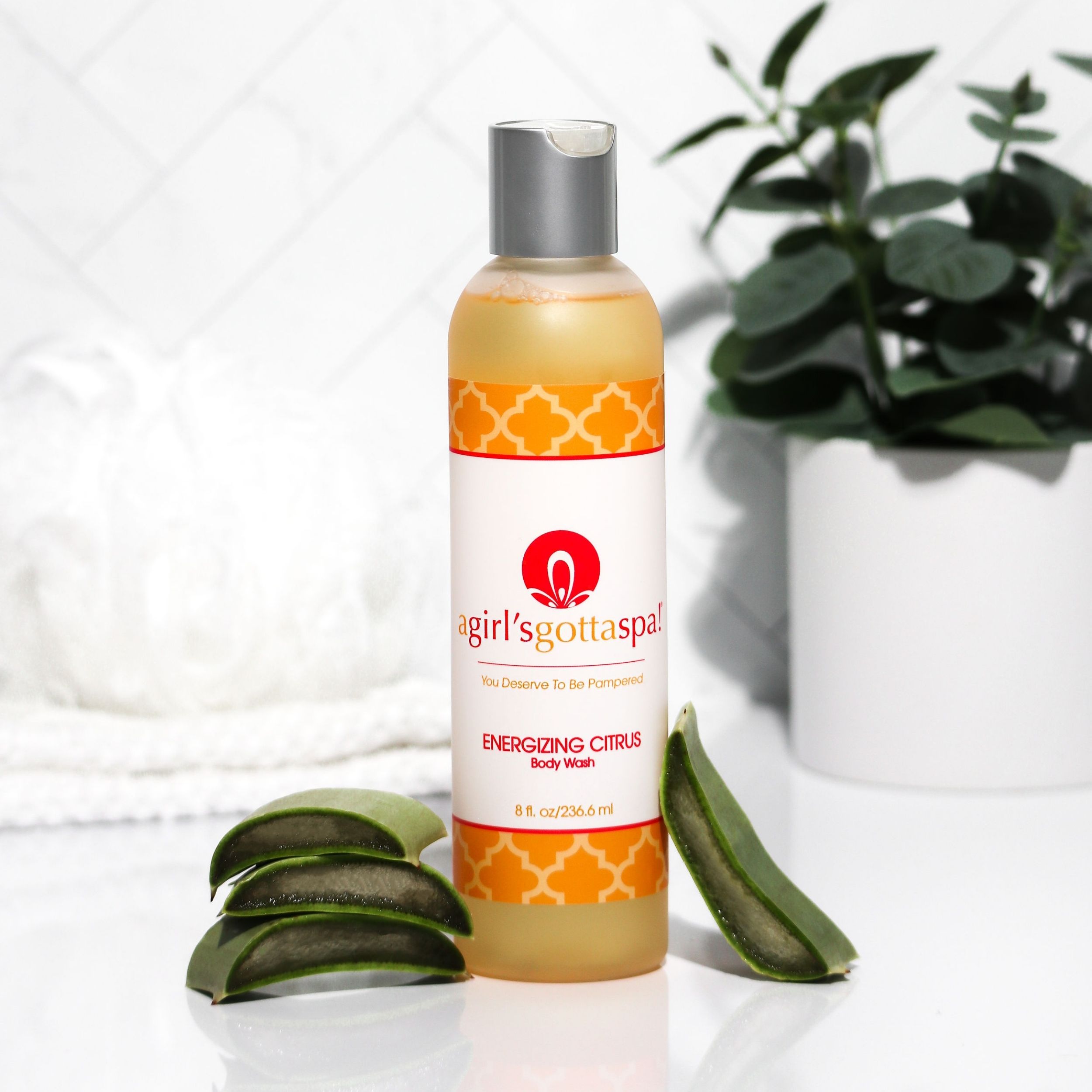 A bottle of A Girl's Gotta Spa! Energizing Citrus Body Wash featuring a vibrant citrus design, showcasing its refreshing and hydrating properties.