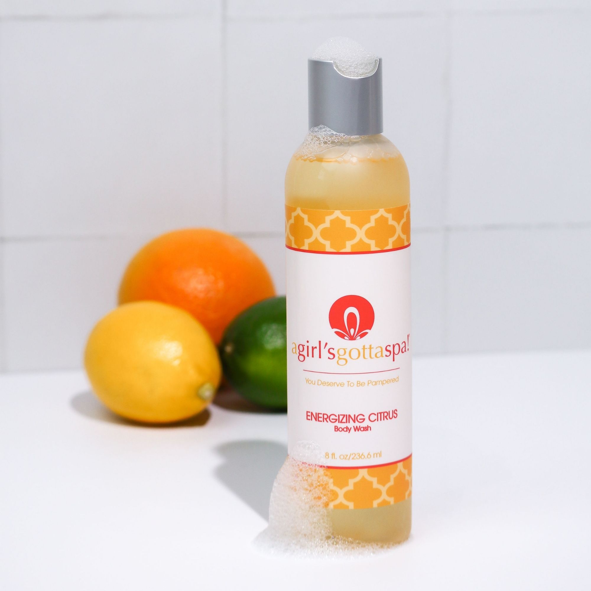 A bottle of A Girl's Gotta Spa! Energizing Citrus Body Wash featuring a vibrant citrus design, showcasing its refreshing and hydrating properties.