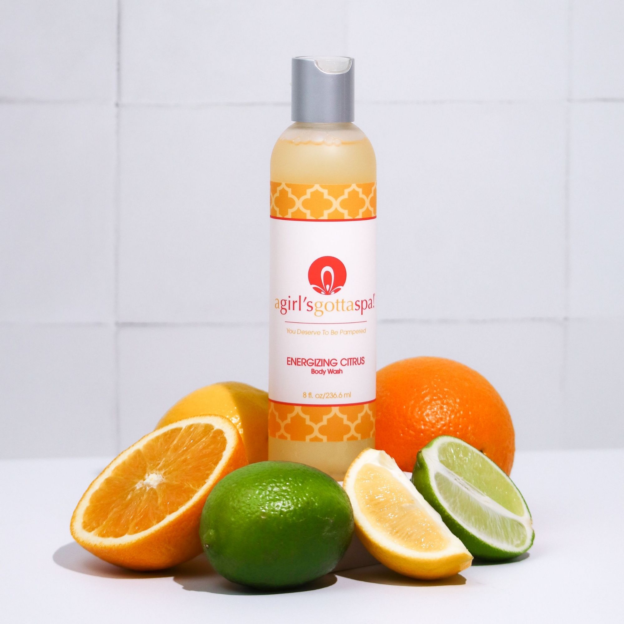 A bottle of A Girl's Gotta Spa! Energizing Citrus Body Wash featuring a vibrant citrus design, showcasing its refreshing and hydrating properties.