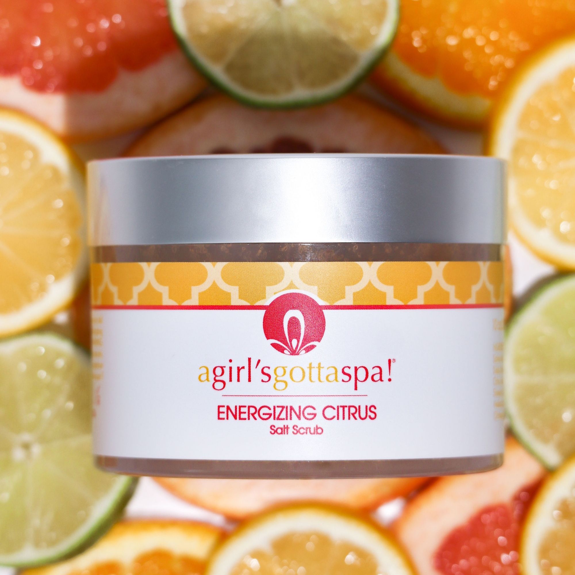 Energizing Citrus Salt Body Scrub in a jar with a wooden spoon, showcasing its vibrant texture and citrus scent.