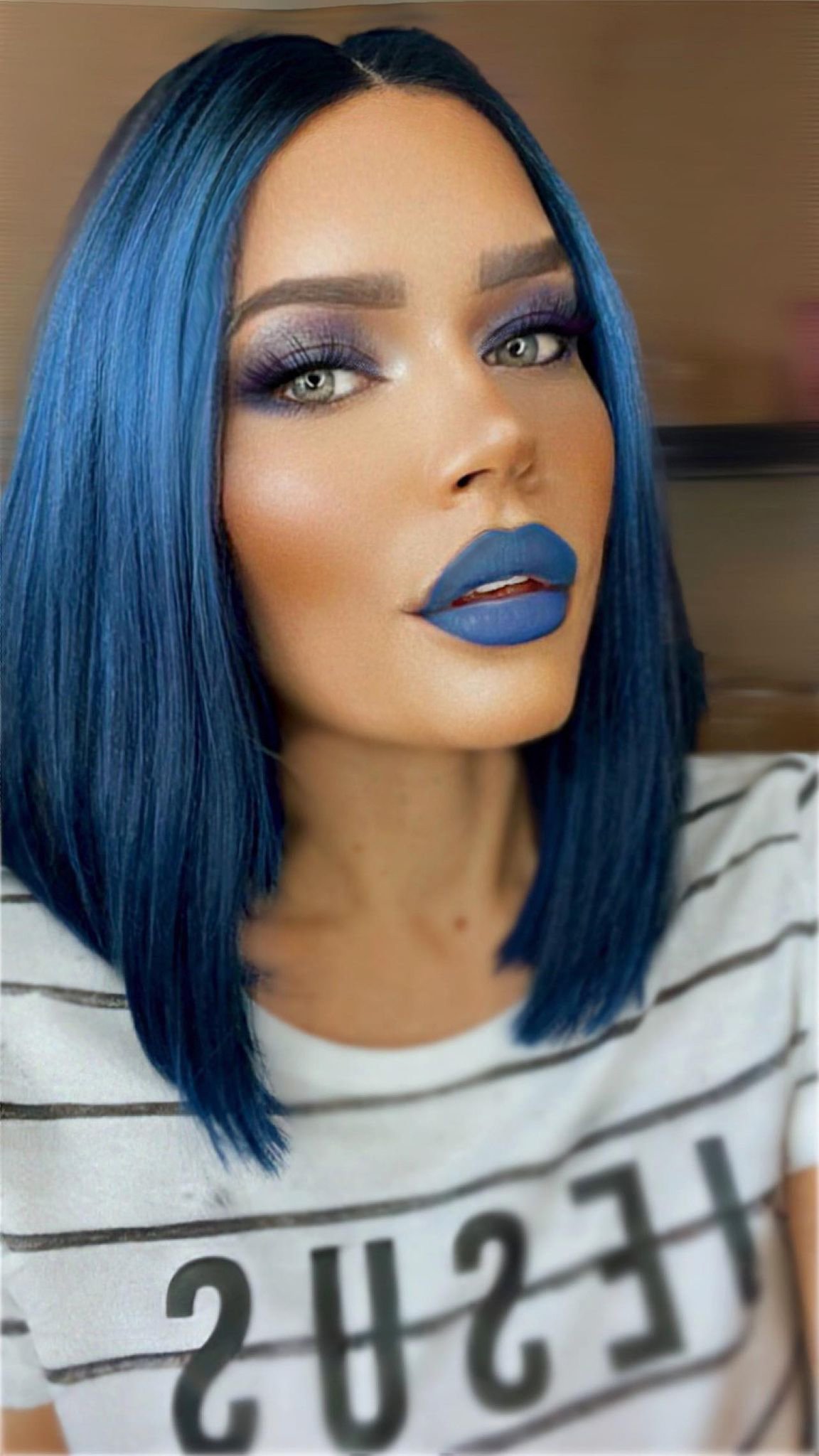 Envy wig in Blue Ombre featuring a blend from black to light blue, showcasing high-end synthetic fibers and a transparent lace front.