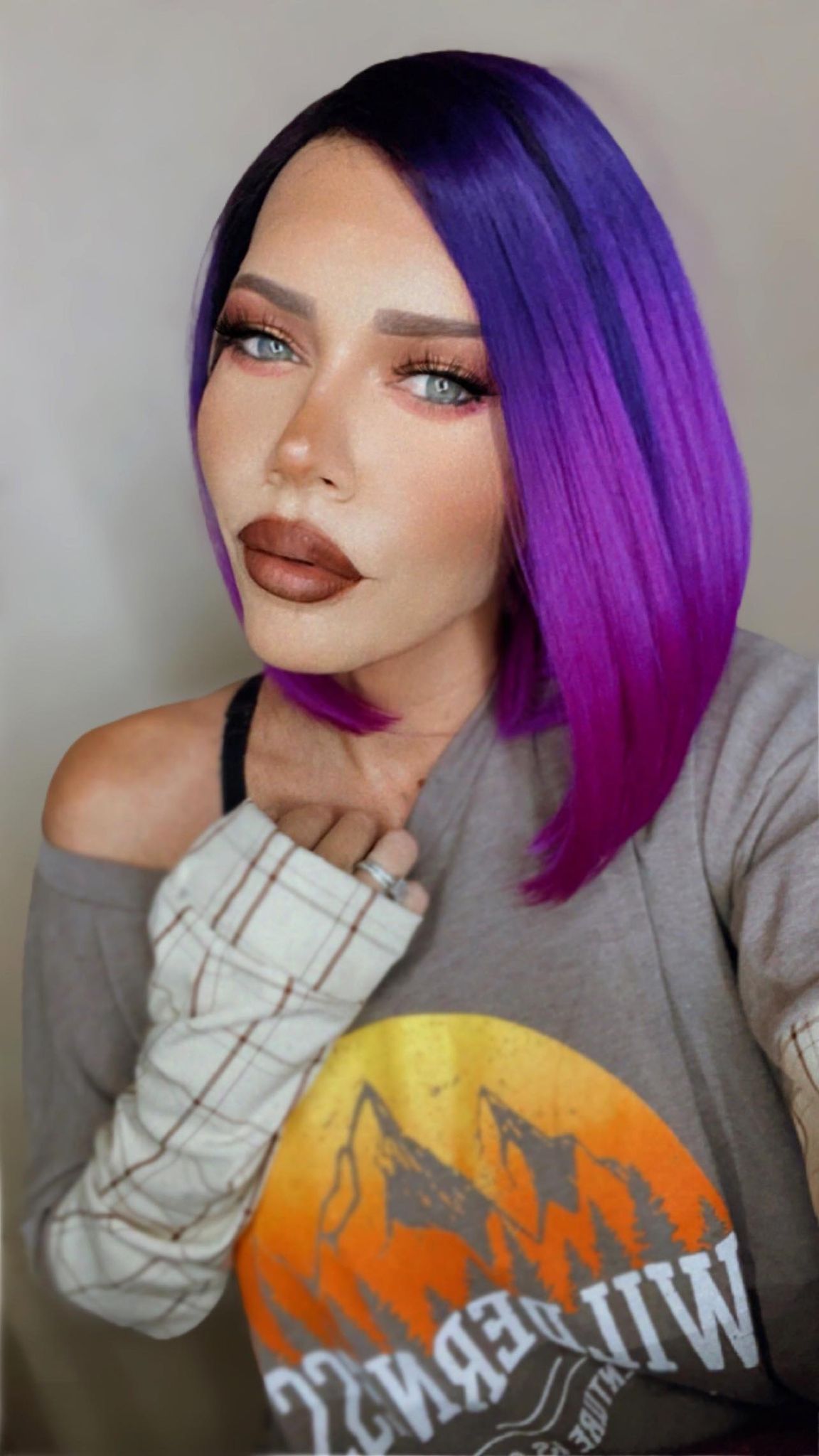 Envy (Purple Ombre') wig showcasing a beautiful ombre transition from black to deep purple to vibrant purple, featuring a transparent lace front.