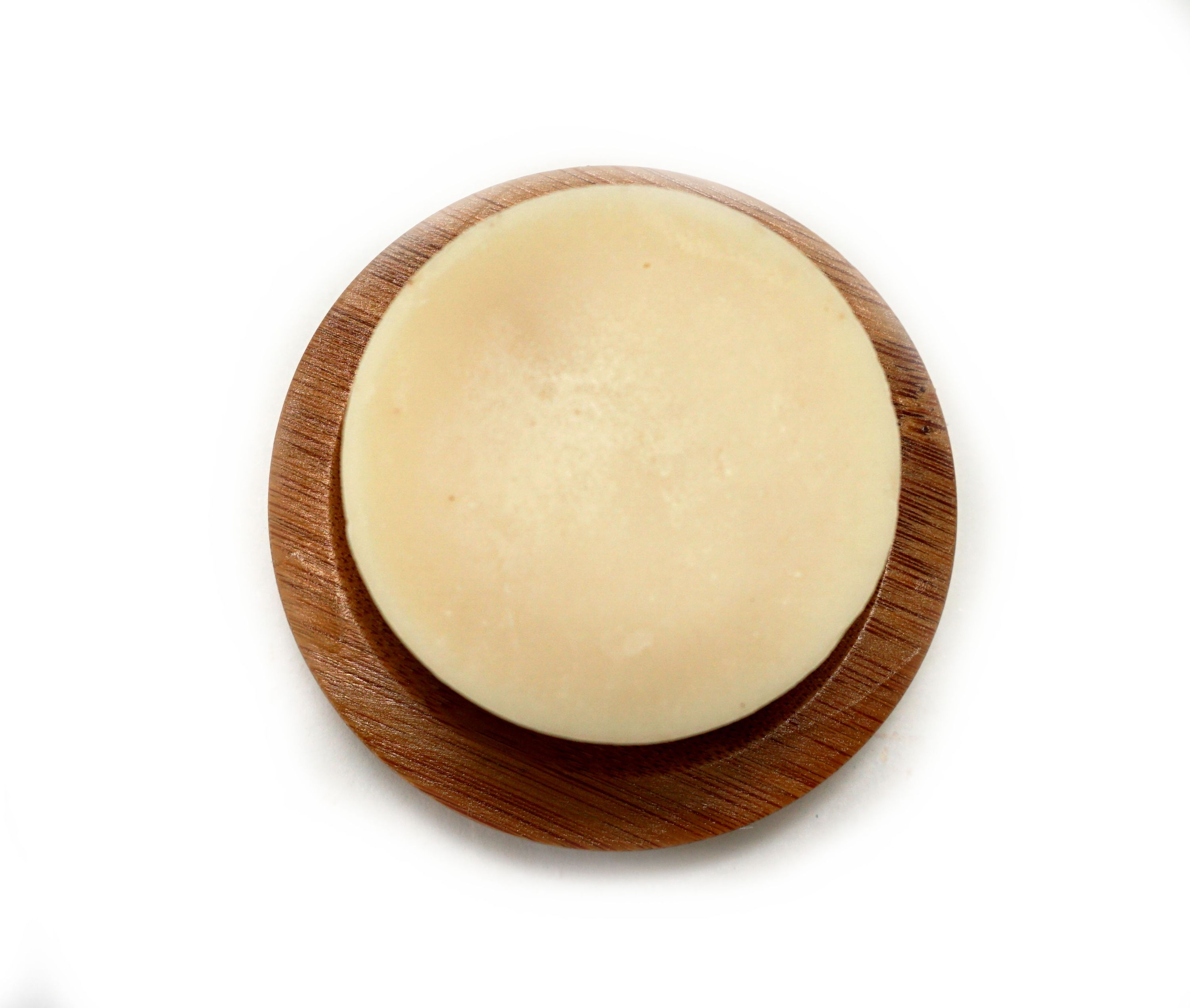 Eucalyptus Lemon Shampoo Bar, a plastic-free solid shampoo with natural ingredients, displayed on a wooden surface with eucalyptus leaves.