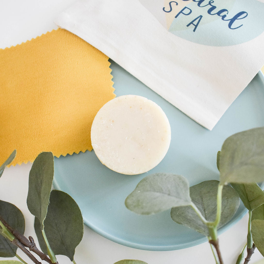 Eucalyptus Lemon Shampoo Bar, a plastic-free solid shampoo with natural ingredients, displayed on a wooden surface with eucalyptus leaves.