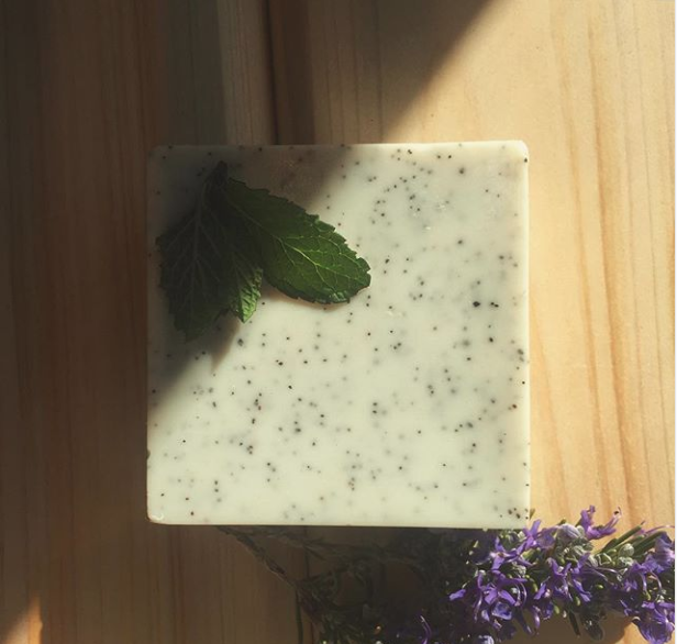 Exfoliating Bath Bars featuring goat's milk and crushed grapeseeds, showcasing creamy texture and natural ingredients.