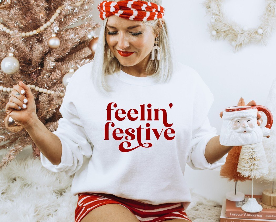 Cozy Feelin' Festive Pullover in various colors, showcasing its soft fabric and unisex design.