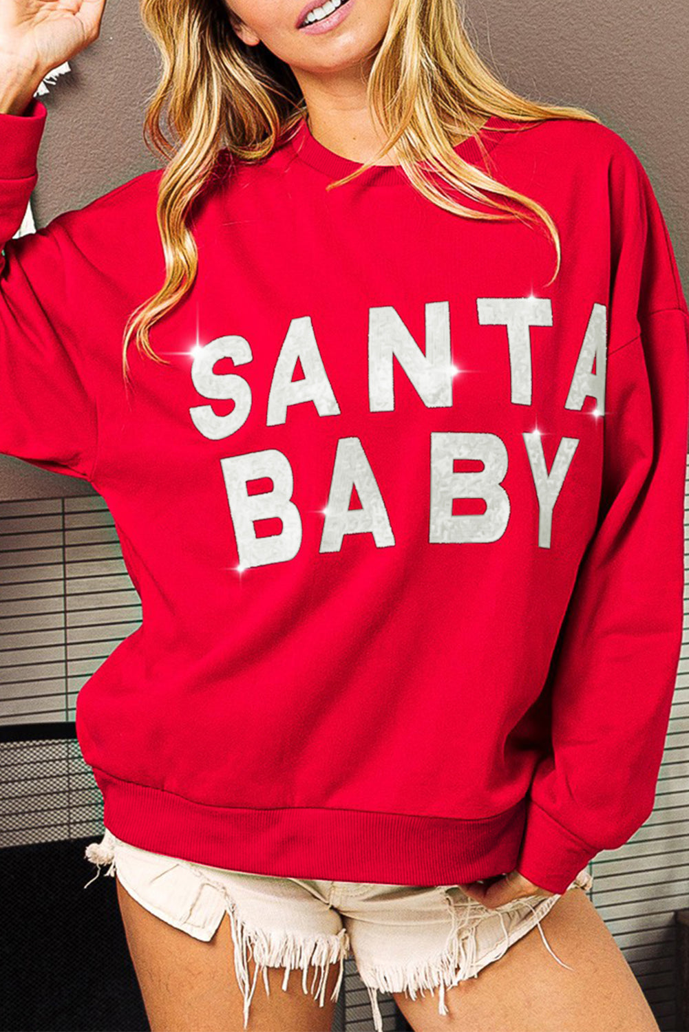 Fiery red sweatshirt featuring a shiny SANTA BABY graphic, perfect for holiday celebrations, with a crew neck and loose fit style.