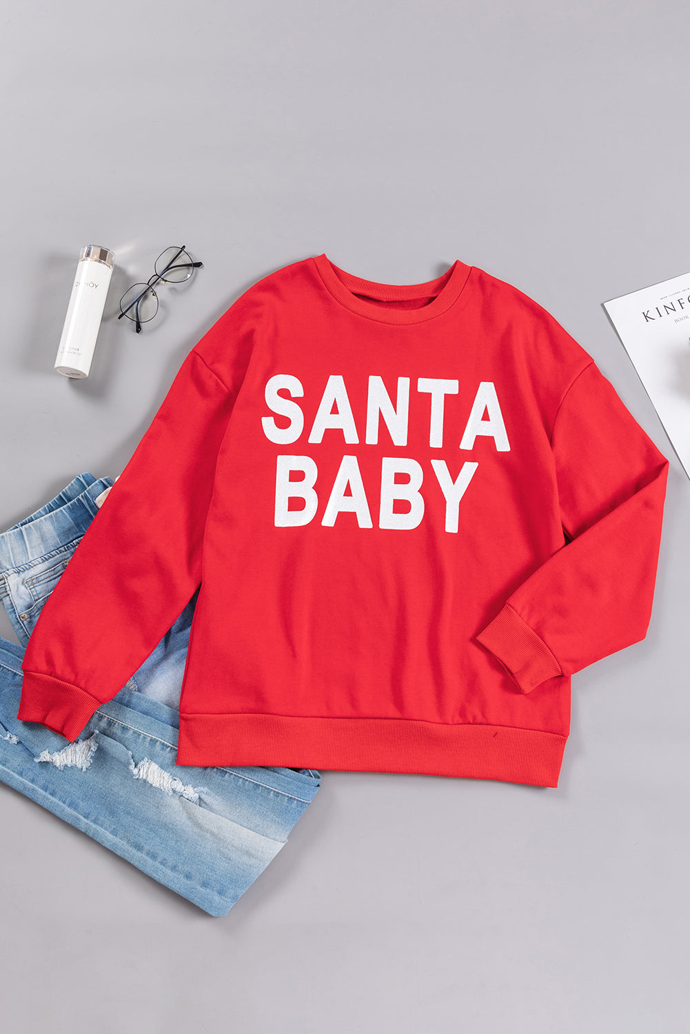 Fiery red sweatshirt featuring a shiny SANTA BABY graphic, perfect for holiday celebrations, with a crew neck and loose fit style.