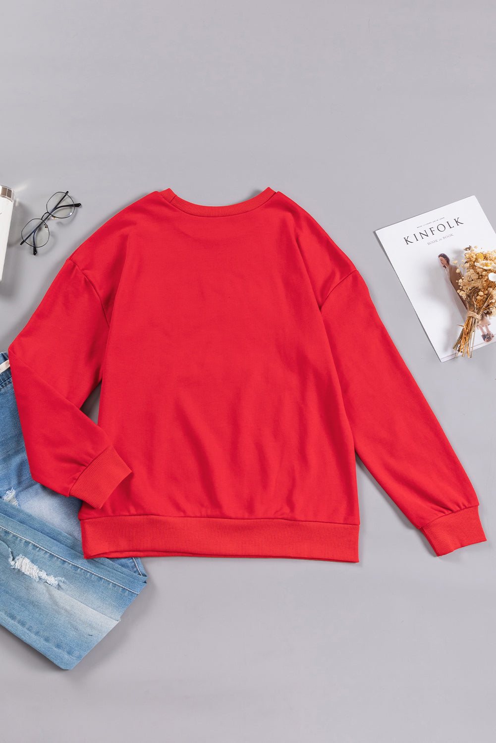 Fiery red sweatshirt featuring a shiny SANTA BABY graphic, perfect for holiday celebrations, with a crew neck and loose fit style.