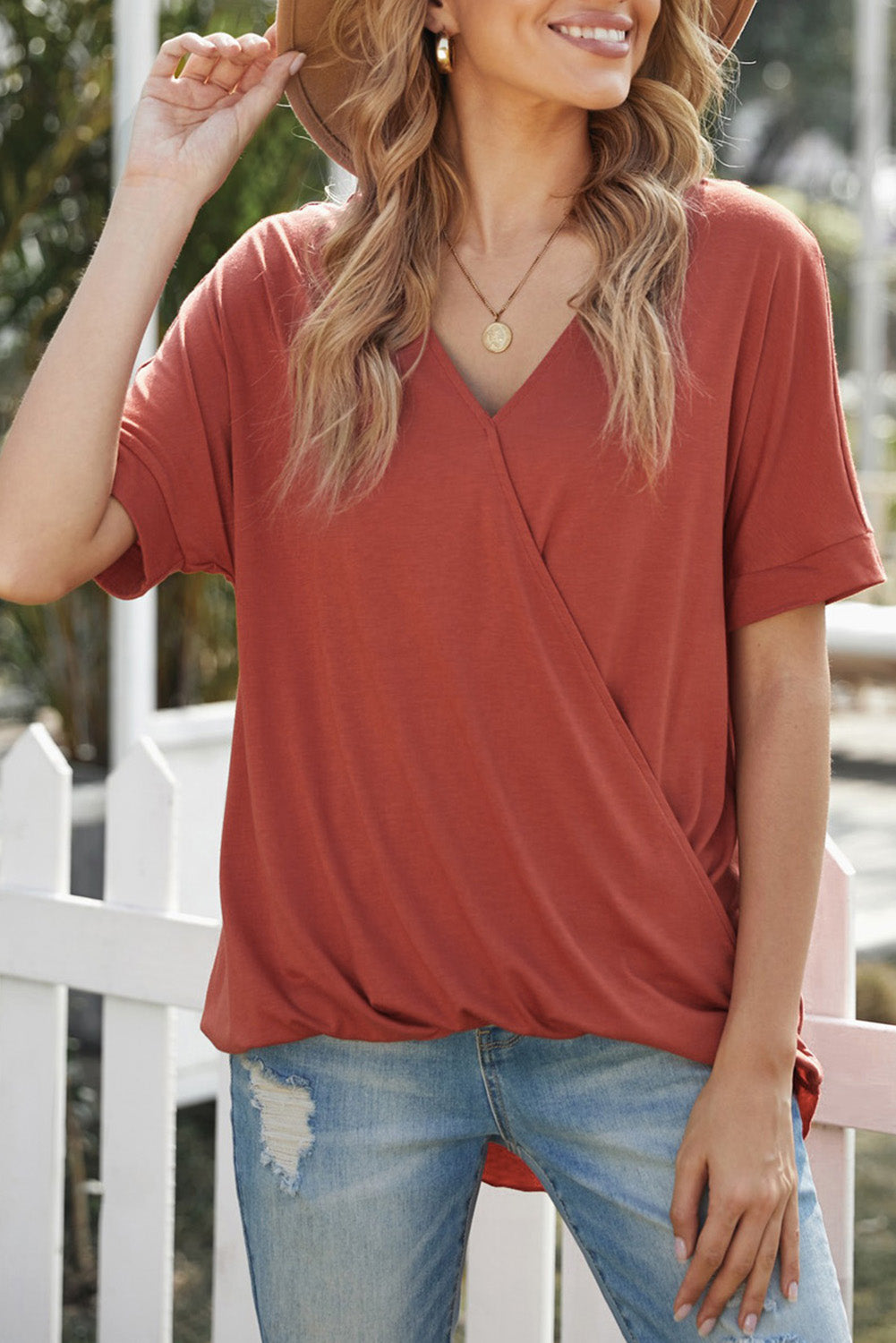 Fiery Red Short Sleeves Drape Knit Top with elegant twist design, featuring a sewn v-neckline and cuffed short sleeves.