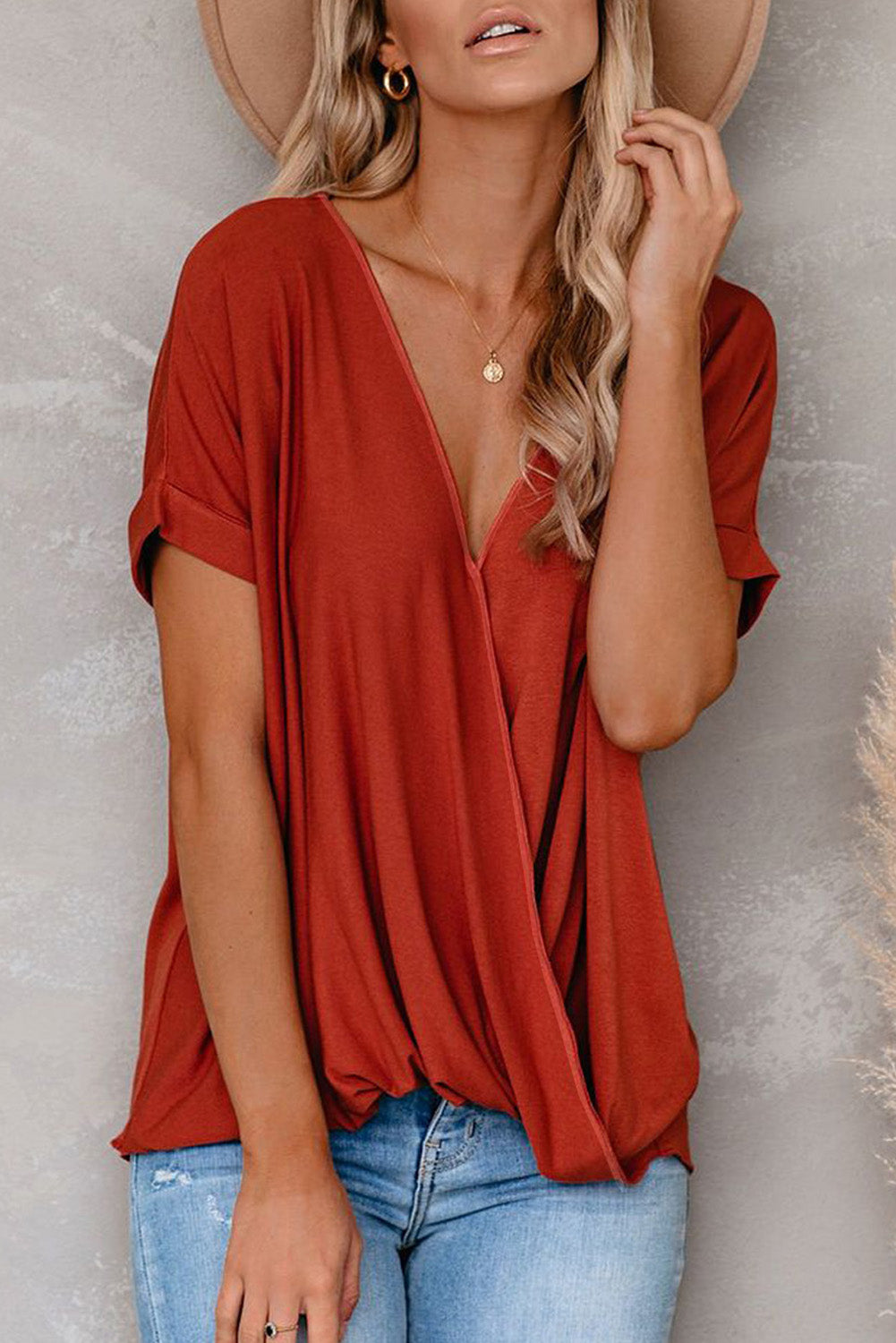 Fiery Red Short Sleeves Drape Knit Top with elegant twist design, featuring a sewn v-neckline and cuffed short sleeves.