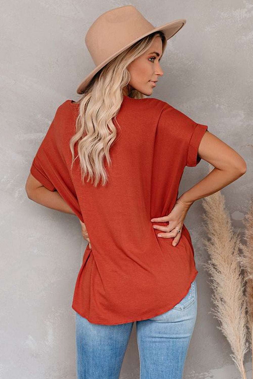 Fiery Red Short Sleeves Drape Knit Top with elegant twist design, featuring a sewn v-neckline and cuffed short sleeves.