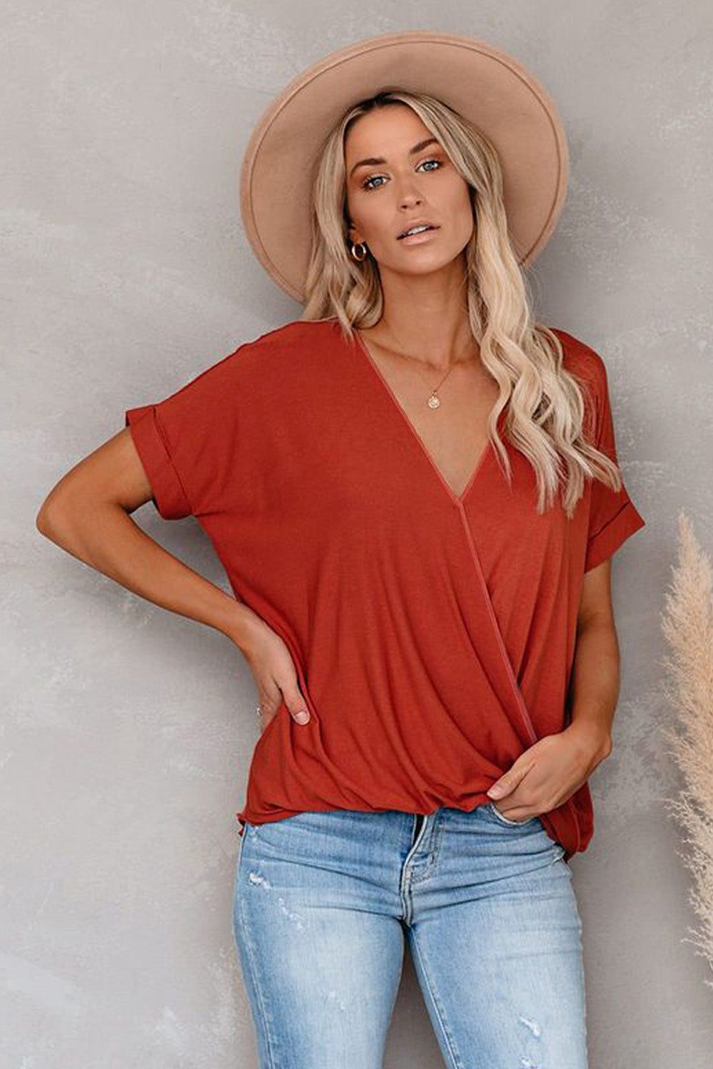 Fiery Red Short Sleeves Drape Knit Top with elegant twist design, featuring a sewn v-neckline and cuffed short sleeves.