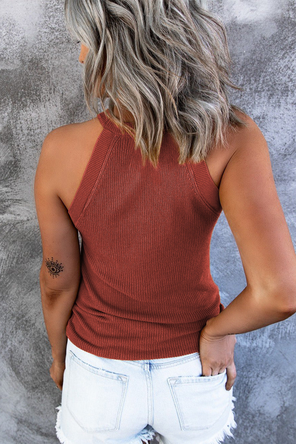 Fiery red solid ribbed knit slim-fit tank top displayed on a mannequin, showcasing its stylish design and texture.