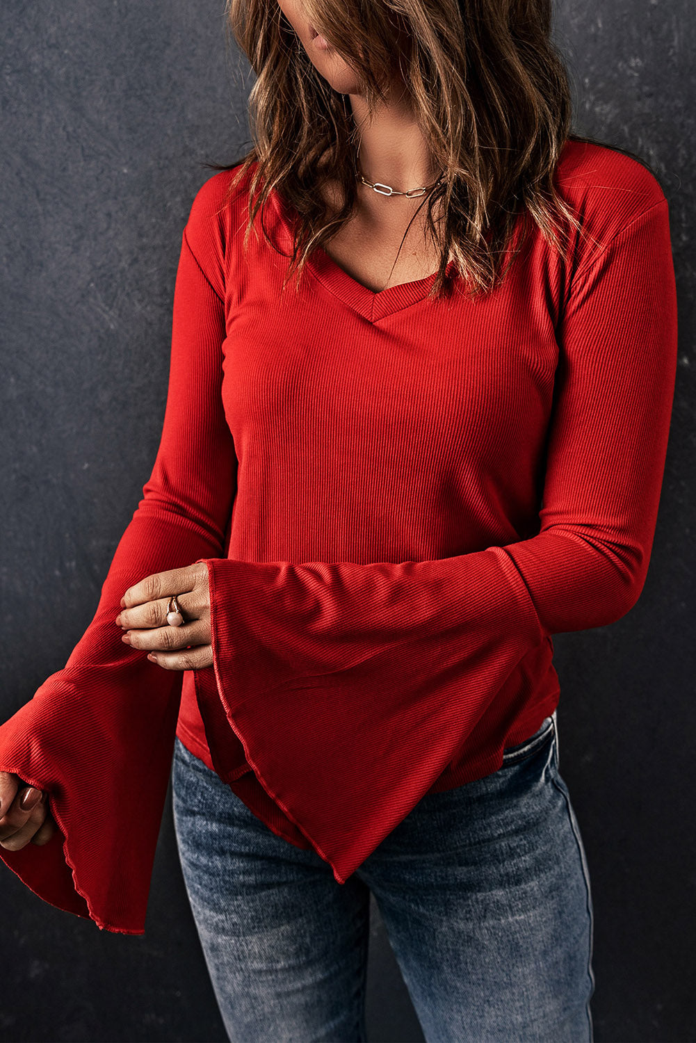 Fiery Red V Neck Knit Bell Sleeve Top with ribbed texture and stylish bell sleeves, perfect for layering or wearing alone.