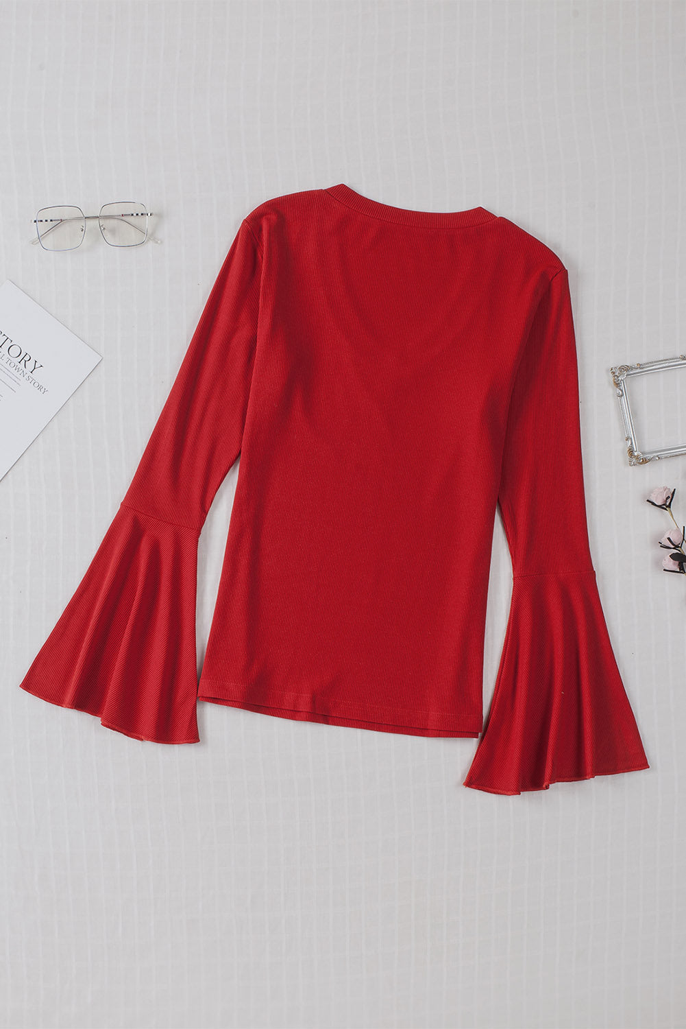 Fiery Red V Neck Knit Bell Sleeve Top with ribbed texture and stylish bell sleeves, perfect for layering or wearing alone.