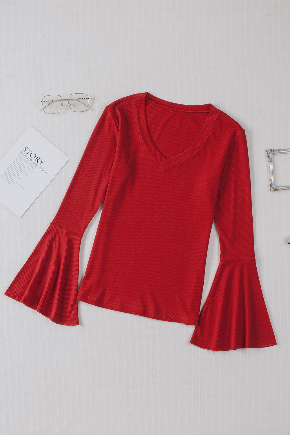 Fiery Red V Neck Knit Bell Sleeve Top with ribbed texture and stylish bell sleeves, perfect for layering or wearing alone.