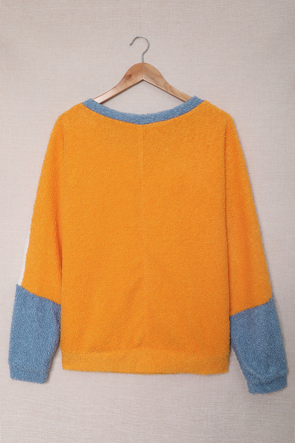 Fleece Colorblock Dolman Sleeves Pullover Top showcasing a mild heart neckline and stylish colorblock design.