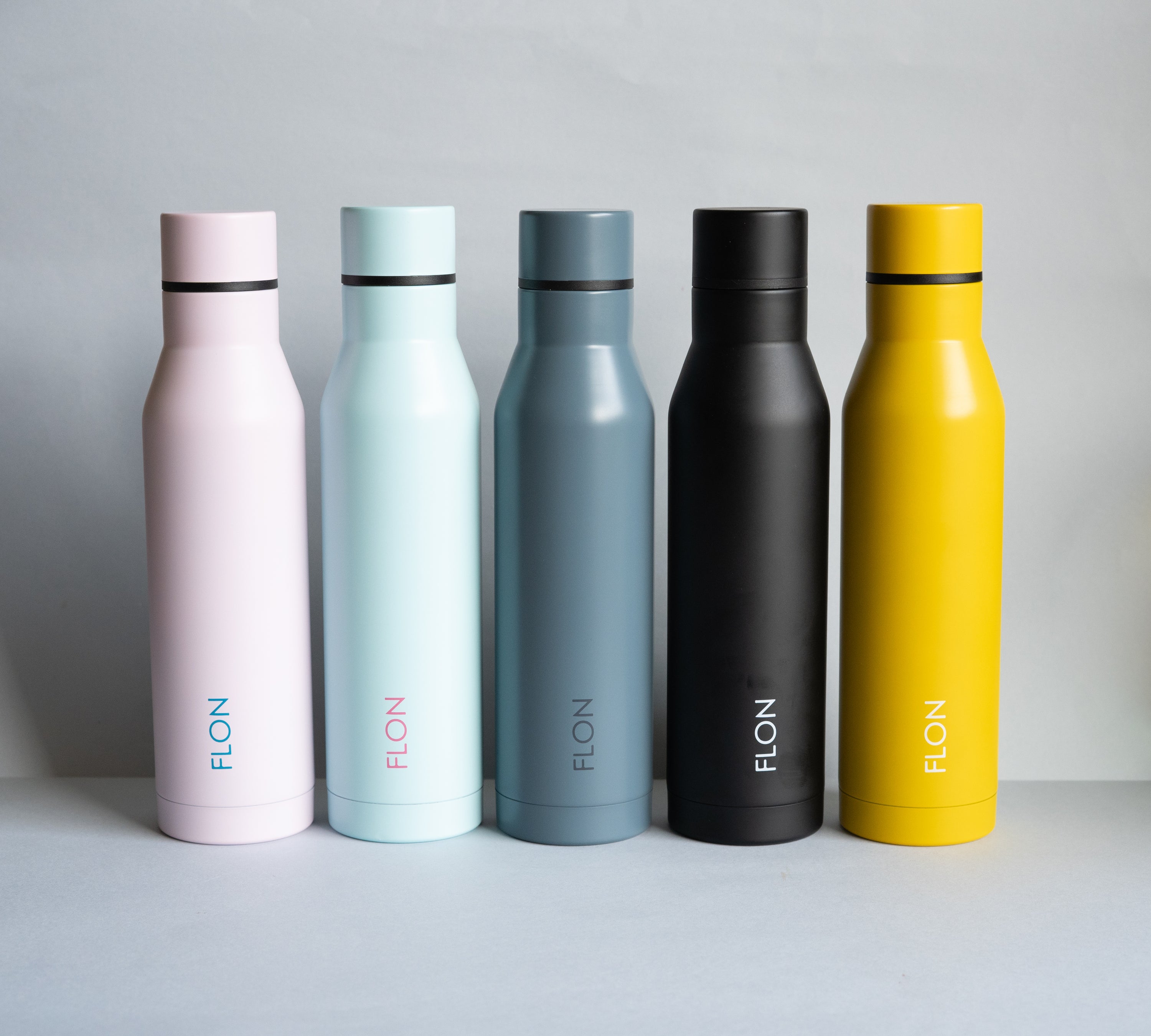 FLON Water Bottle 500ml in vibrant colors, showcasing its stainless steel body and sturdy design.