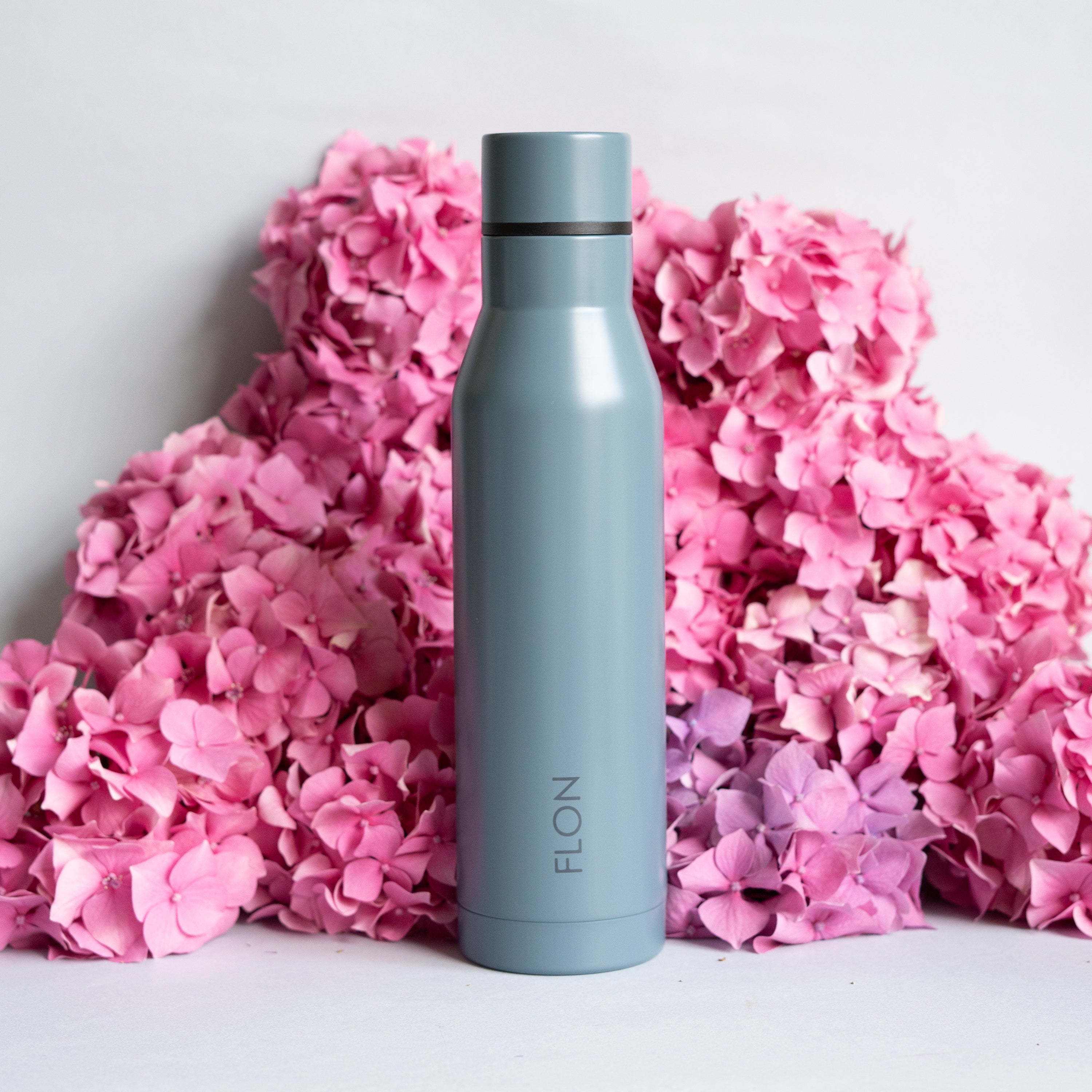 FLON Water Bottle 500ml in vibrant colors, showcasing its stainless steel body and sturdy design.