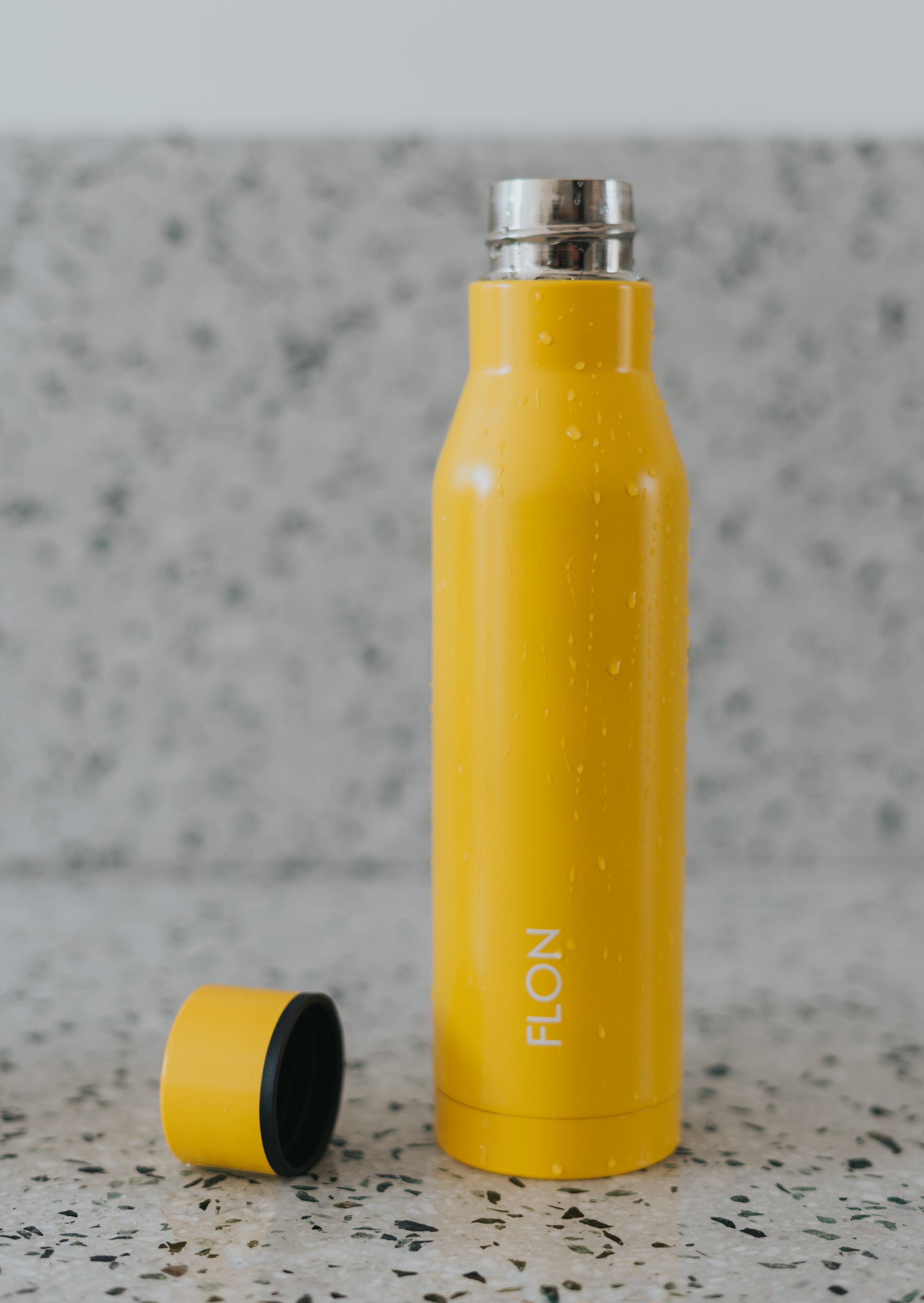 FLON Water Bottle 500ml in vibrant colors, showcasing its stainless steel body and sturdy design.