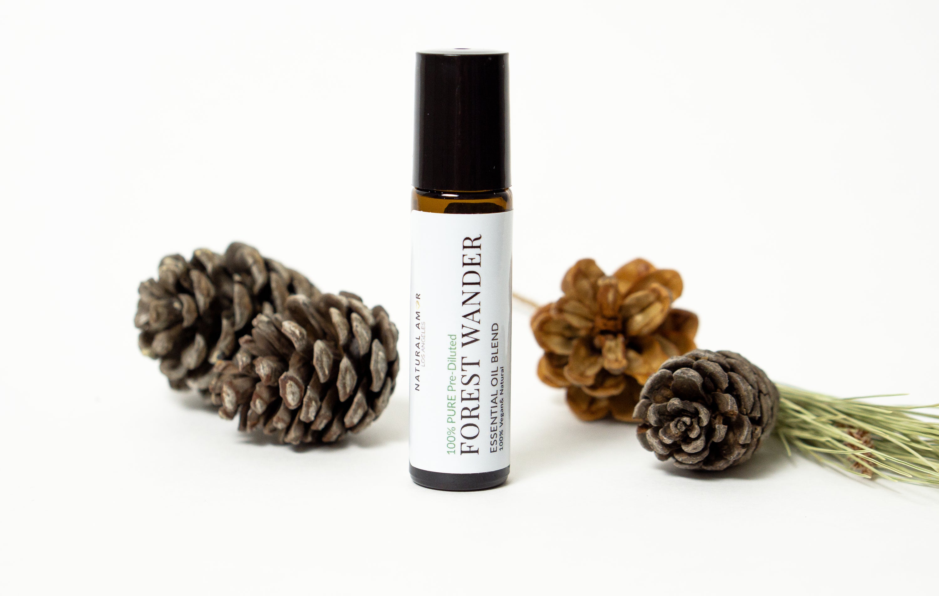 Forest Wander Roll On Essential Oil Blend in a 10 mL bottle with a stainless steel rollerball, showcasing its natural ingredients and woodsy aroma.