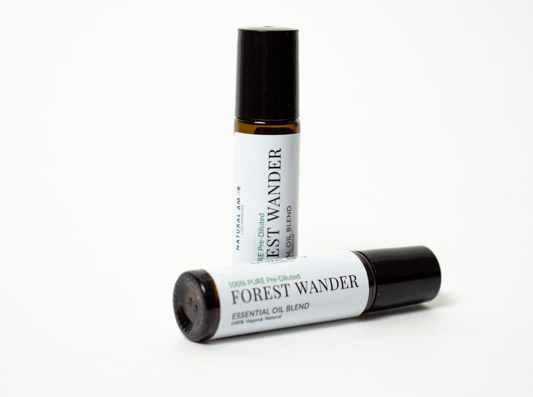 Forest Wander Roll On Essential Oil Blend in a 10 mL bottle with a stainless steel rollerball, showcasing its natural ingredients and woodsy aroma.