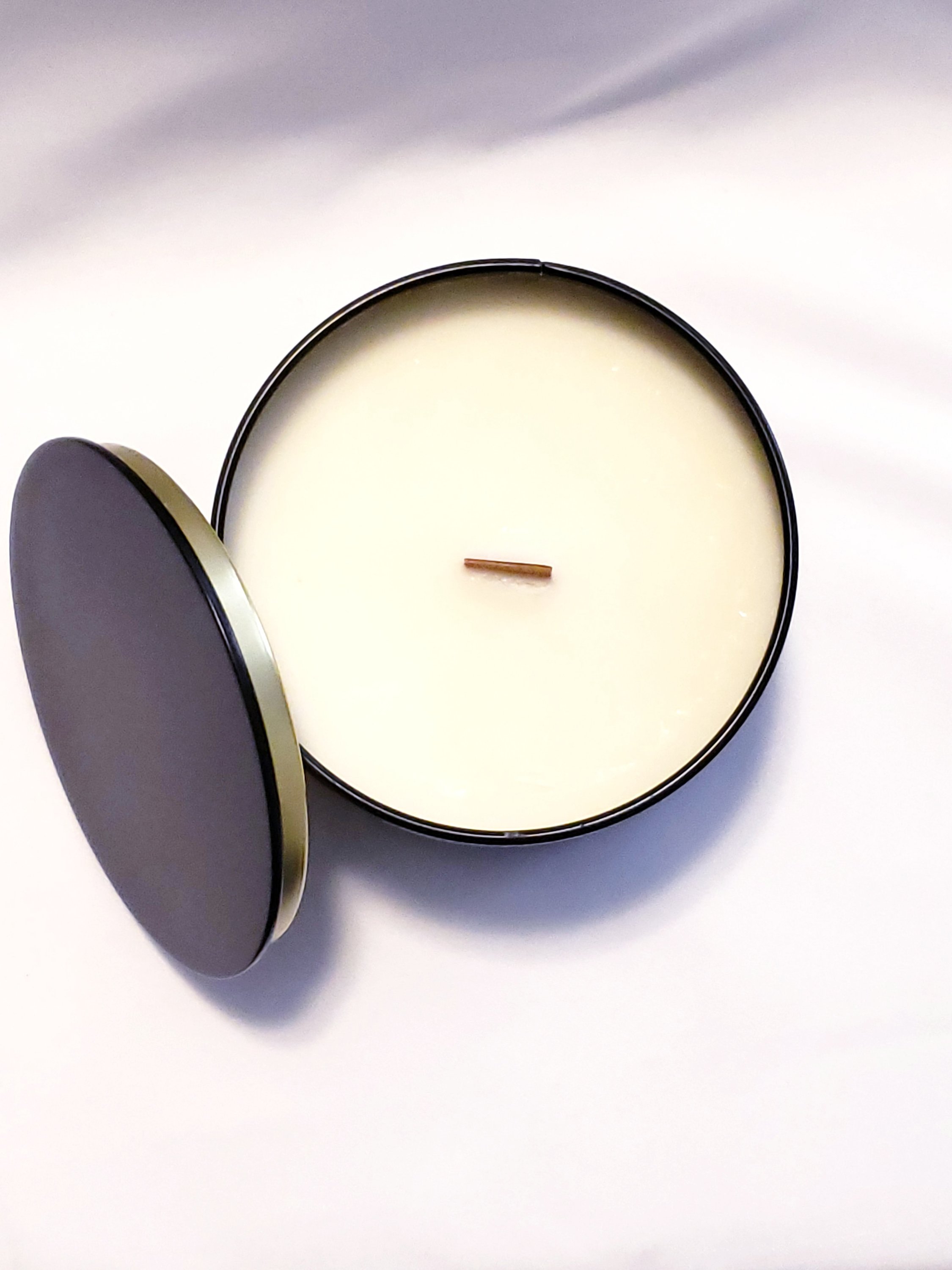 A beautifully crafted Frankincense & Myrrh Candle with a warm glow, showcasing its elegant design and natural essential oil infusion.