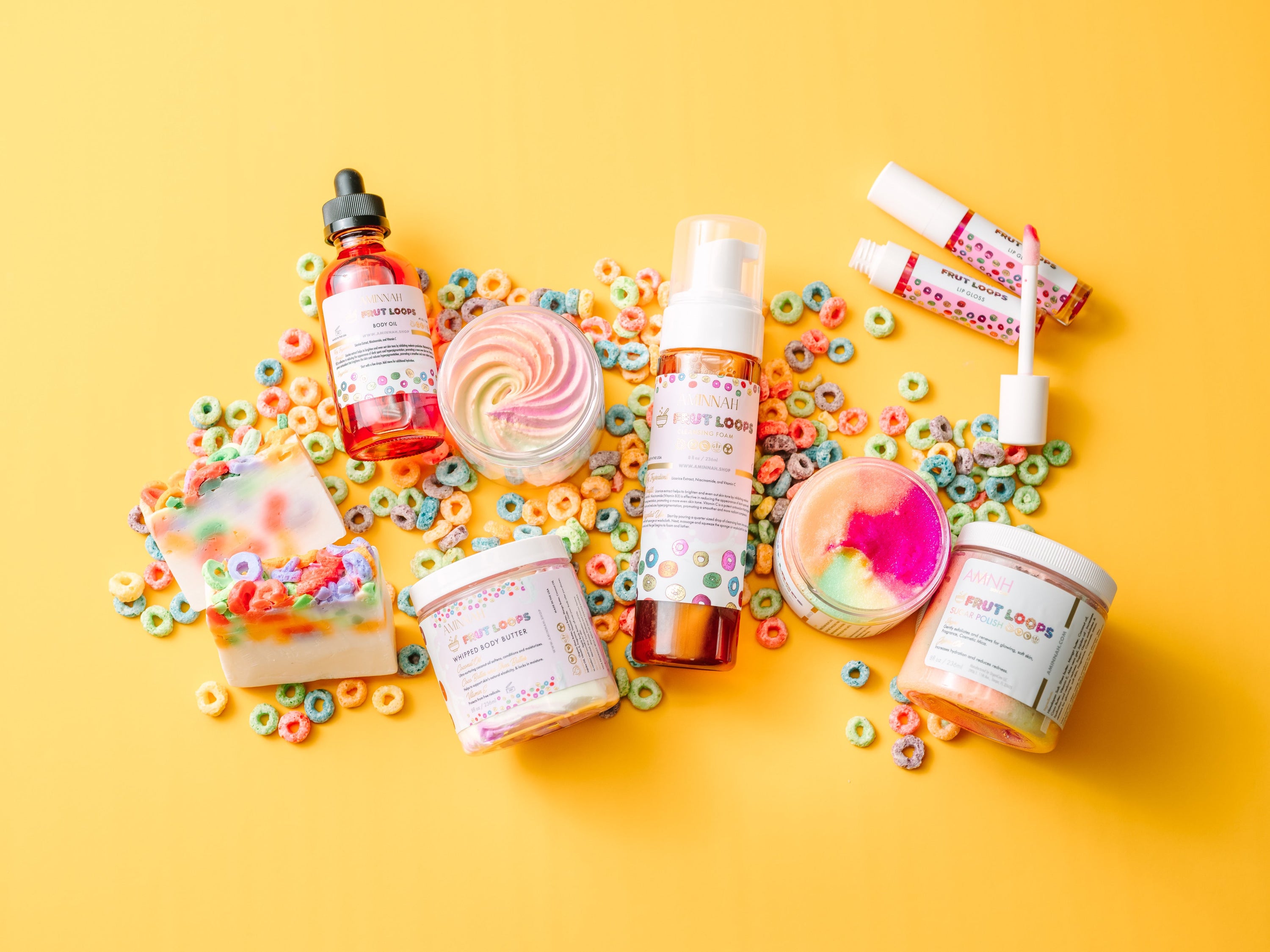 Fruit Loops Bundle featuring body butter, sugar scrub, body oil, cleansing foam, lip gloss, and bar soap with colorful packaging.