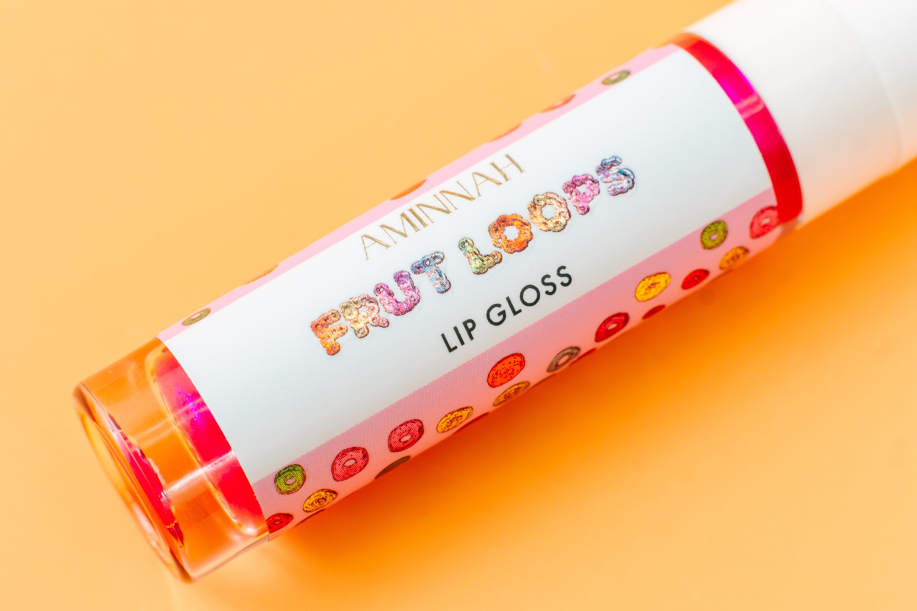 Frut Loops Lip Gloss in colorful packaging, showcasing its fruity flavor and high-shine finish.