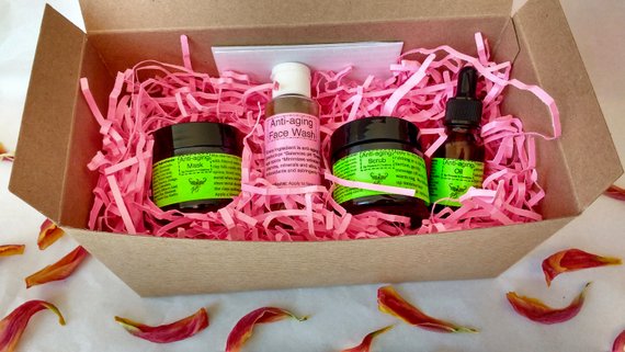 Fully customizable organic vegan gift kit with various skincare products including oils, scrubs, and masks, beautifully packaged.