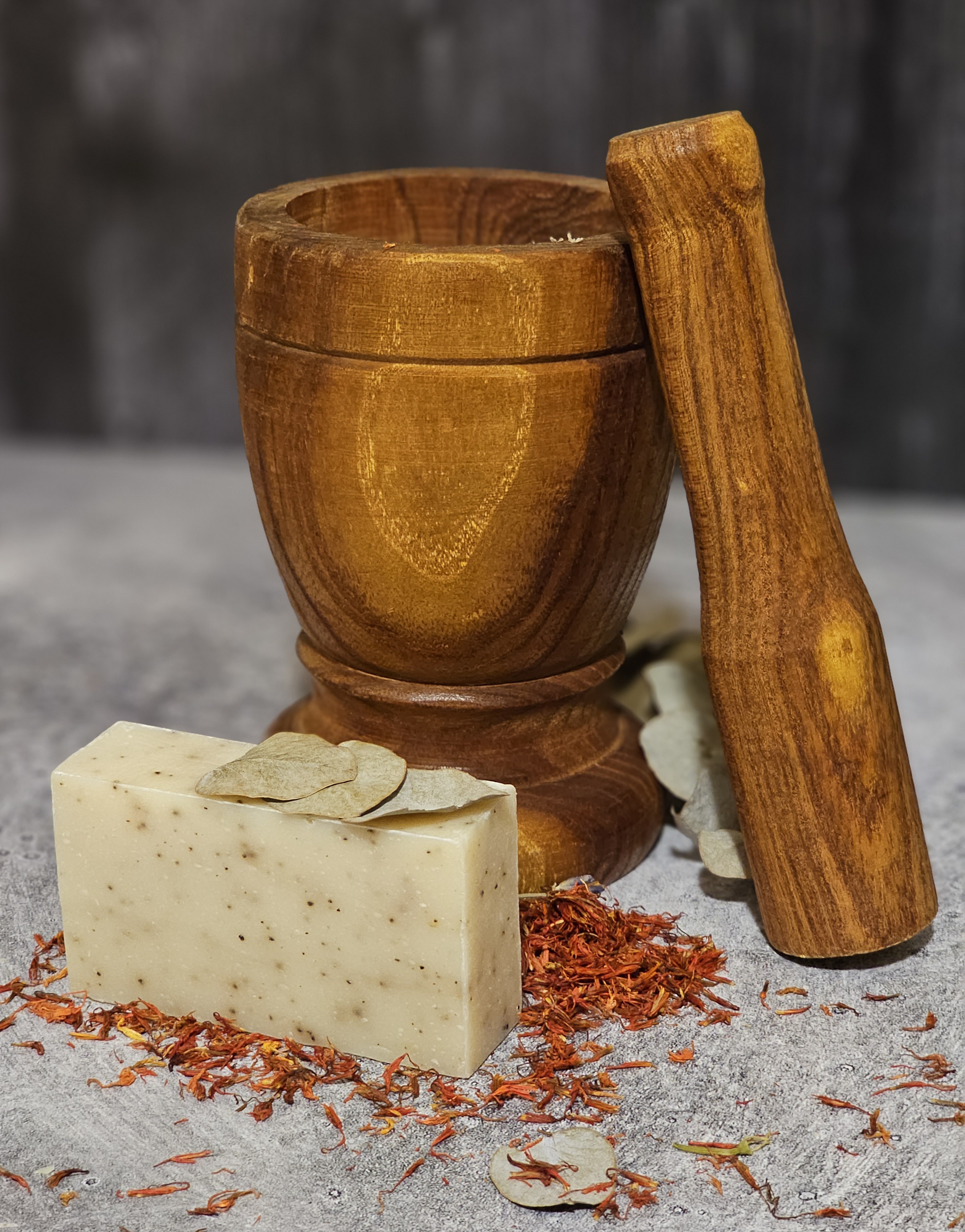 Gardener's Hand Soap bar with coffee grounds and lemon scent, showcasing its organic and vegan ingredients in a rustic setting.