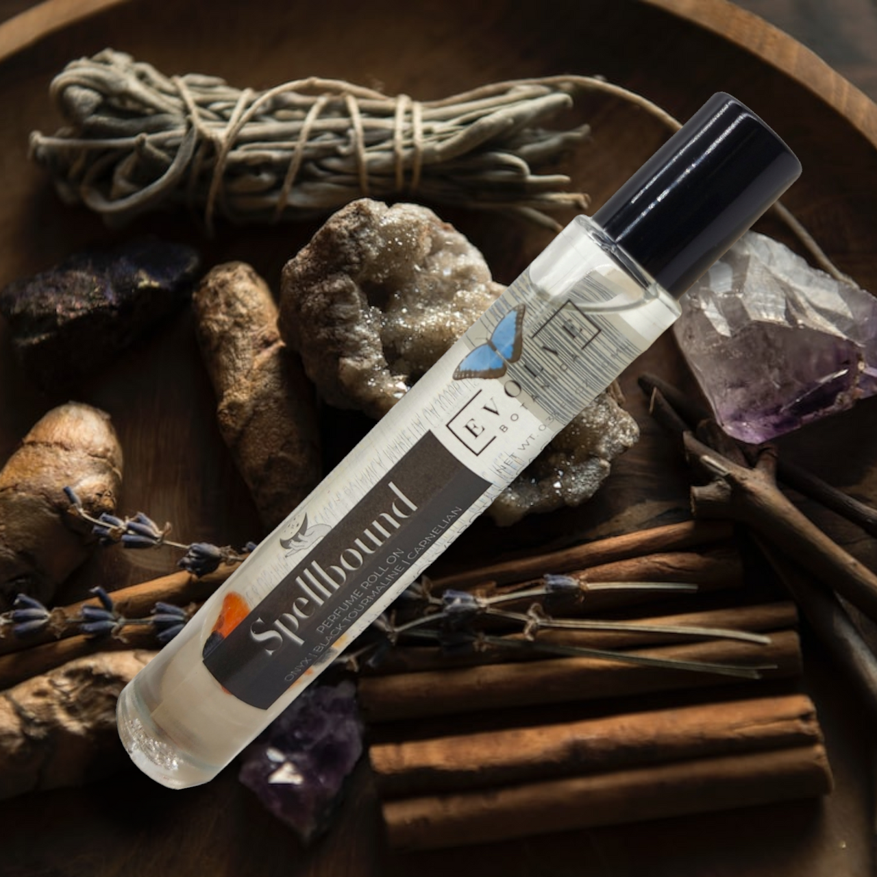 Spellbound Gemstone Perfume Roll On in a glass bottle with stainless steel roller ball, featuring a blend of amber, tobacco, and honey notes.