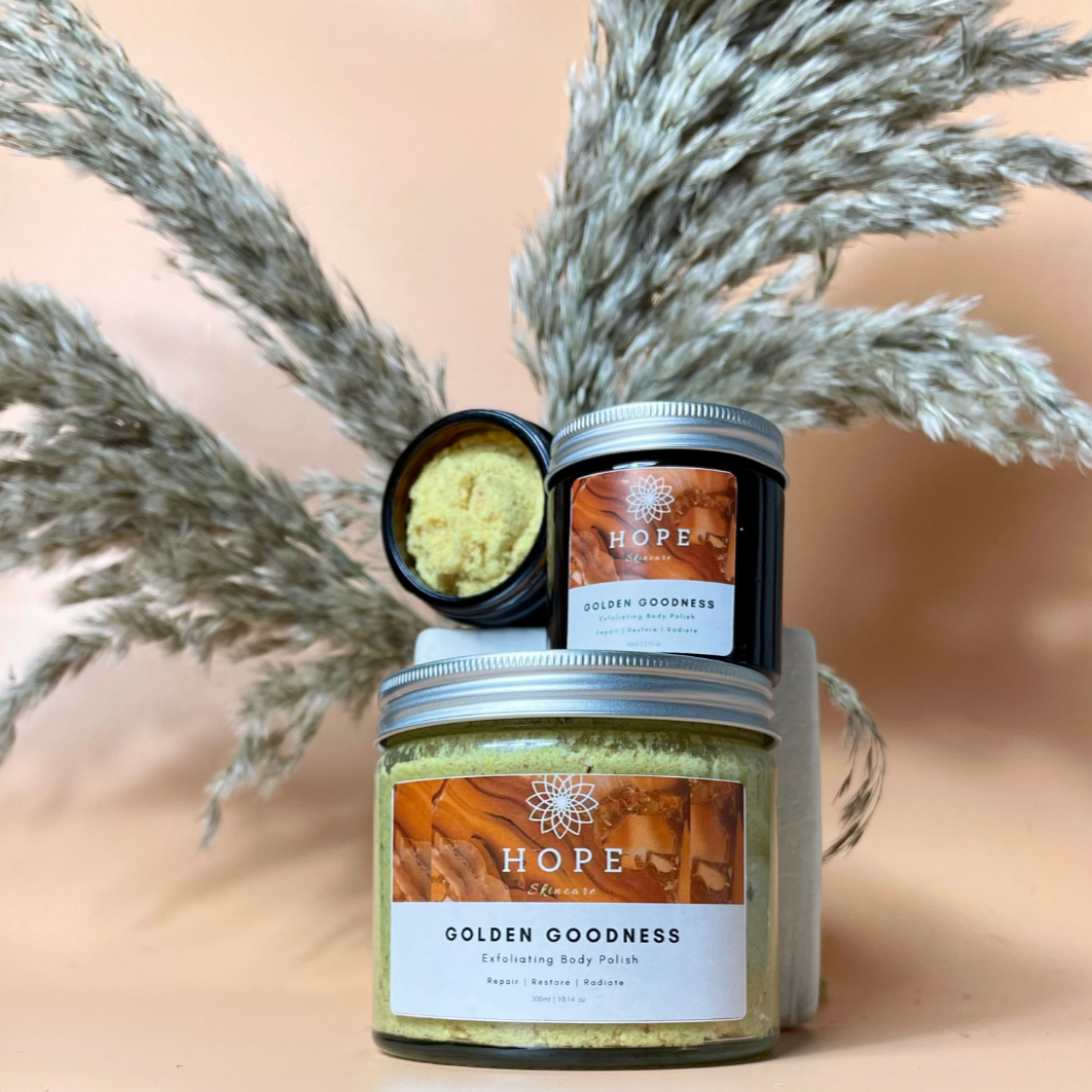 Golden Goodness Exfoliating Body Polish in a jar, showcasing its creamy texture and natural ingredients like papaya and shea butter.