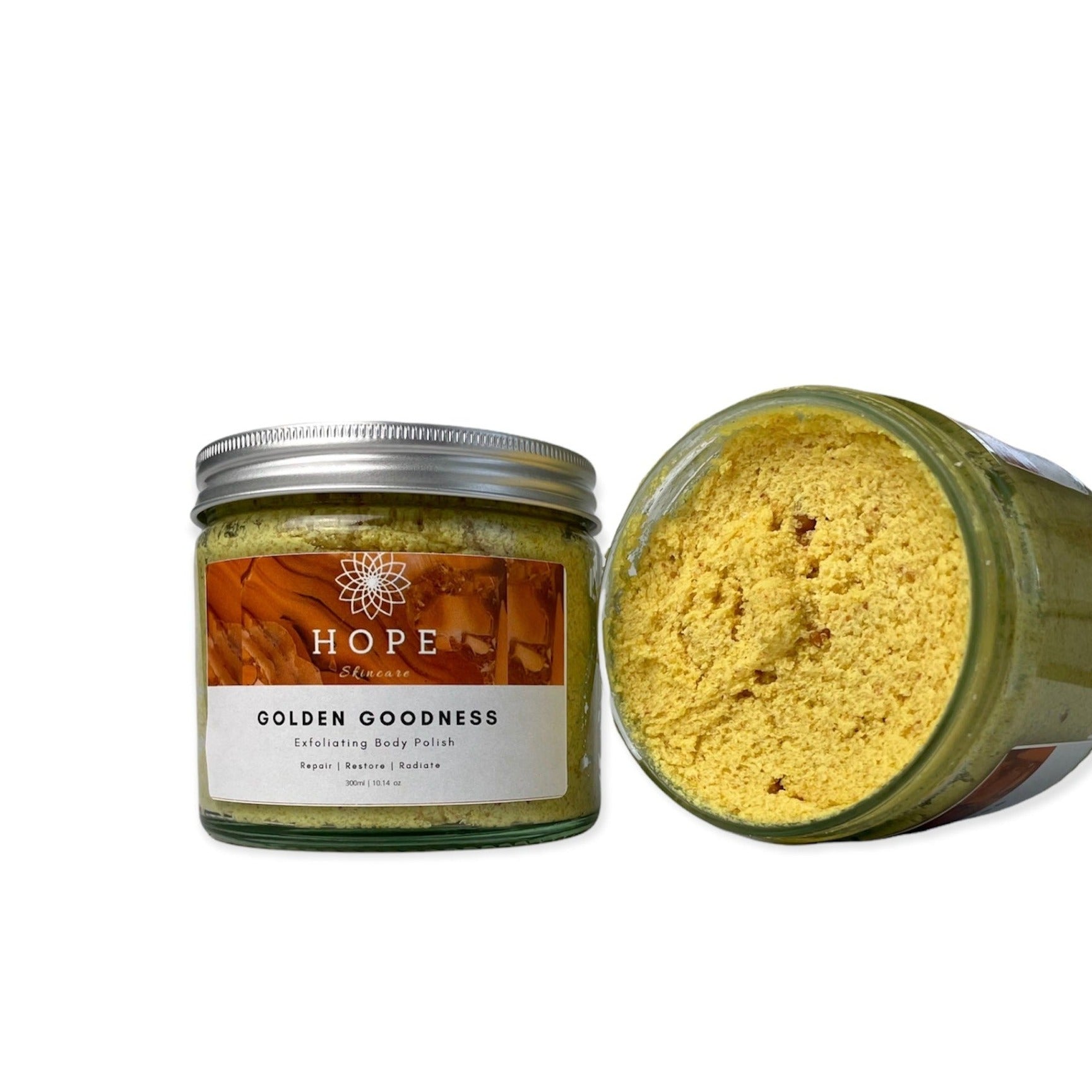 Golden Goodness Exfoliating Body Polish in a jar, showcasing its creamy texture and natural ingredients like papaya and shea butter.