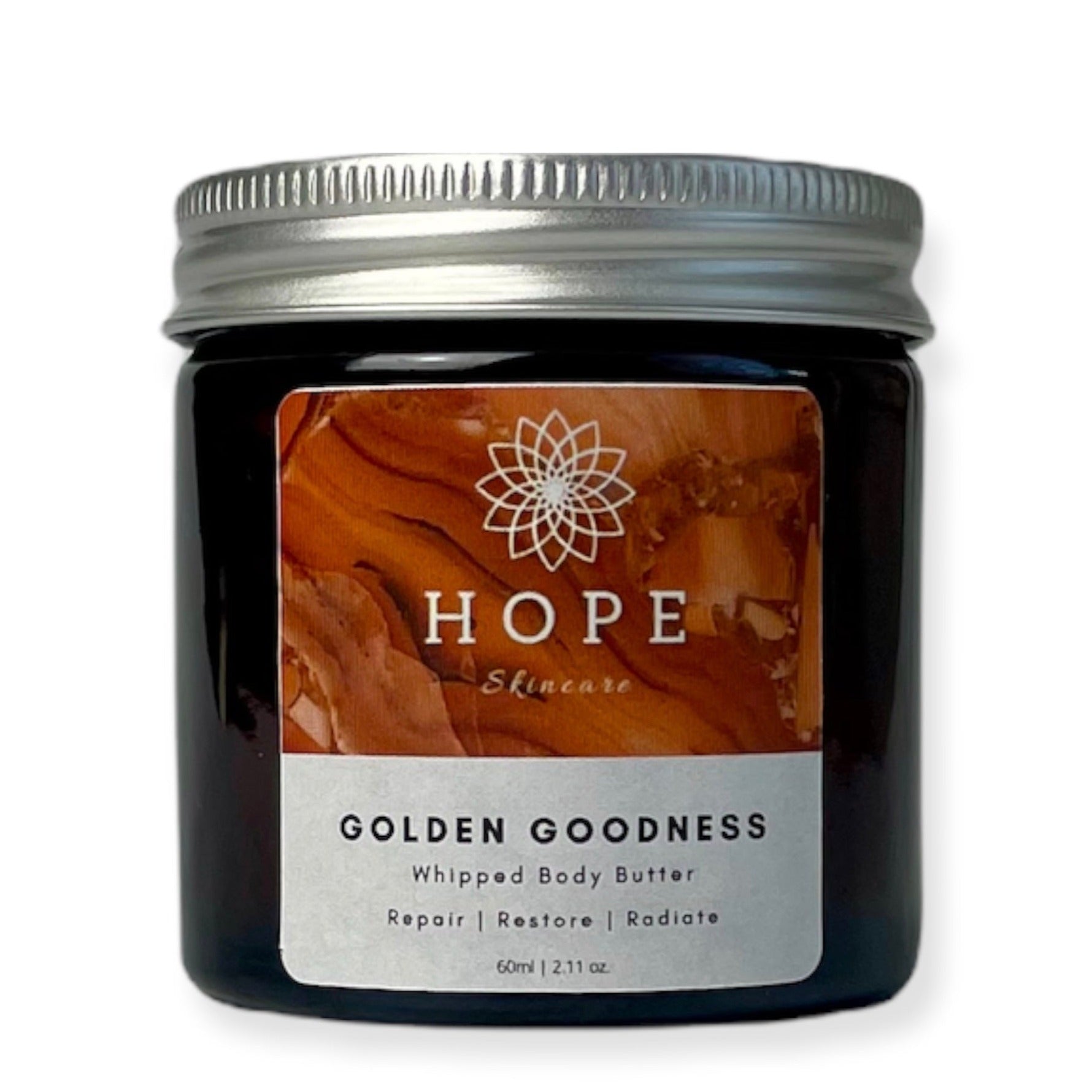 Golden Goodness Whipped Butter in a jar, showcasing its creamy texture and natural ingredients like Manuka honey and turmeric oil.