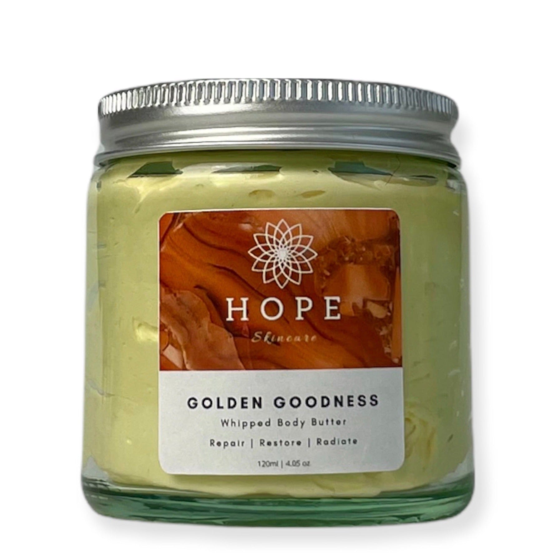 Golden Goodness Whipped Butter in a jar, showcasing its creamy texture and natural ingredients like Manuka honey and turmeric oil.