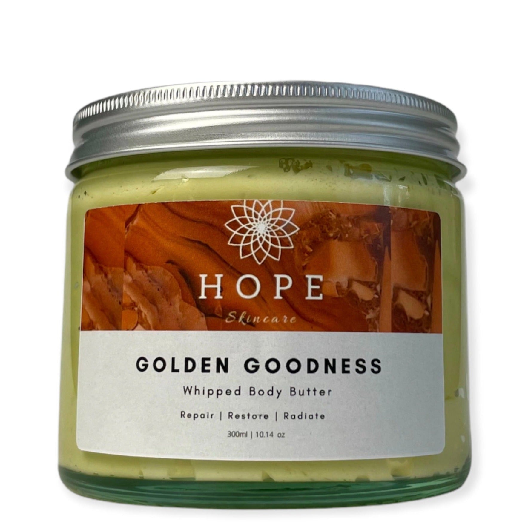 Golden Goodness Whipped Butter in a jar, showcasing its creamy texture and natural ingredients like Manuka honey and turmeric oil.