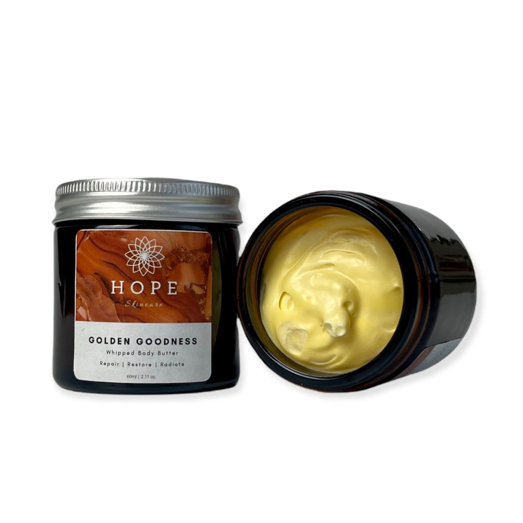 Golden Goodness Whipped Butter in a jar, showcasing its creamy texture and natural ingredients like Manuka honey and turmeric oil.