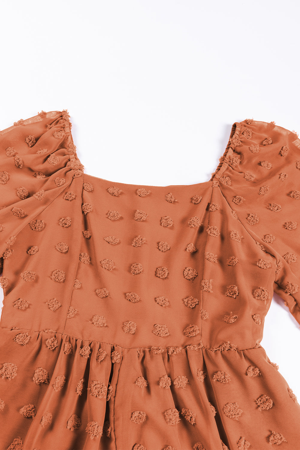 Grapefruit orange swiss dot romper with flounced bubble sleeves and square neck, showcasing a flowy fit silhouette.