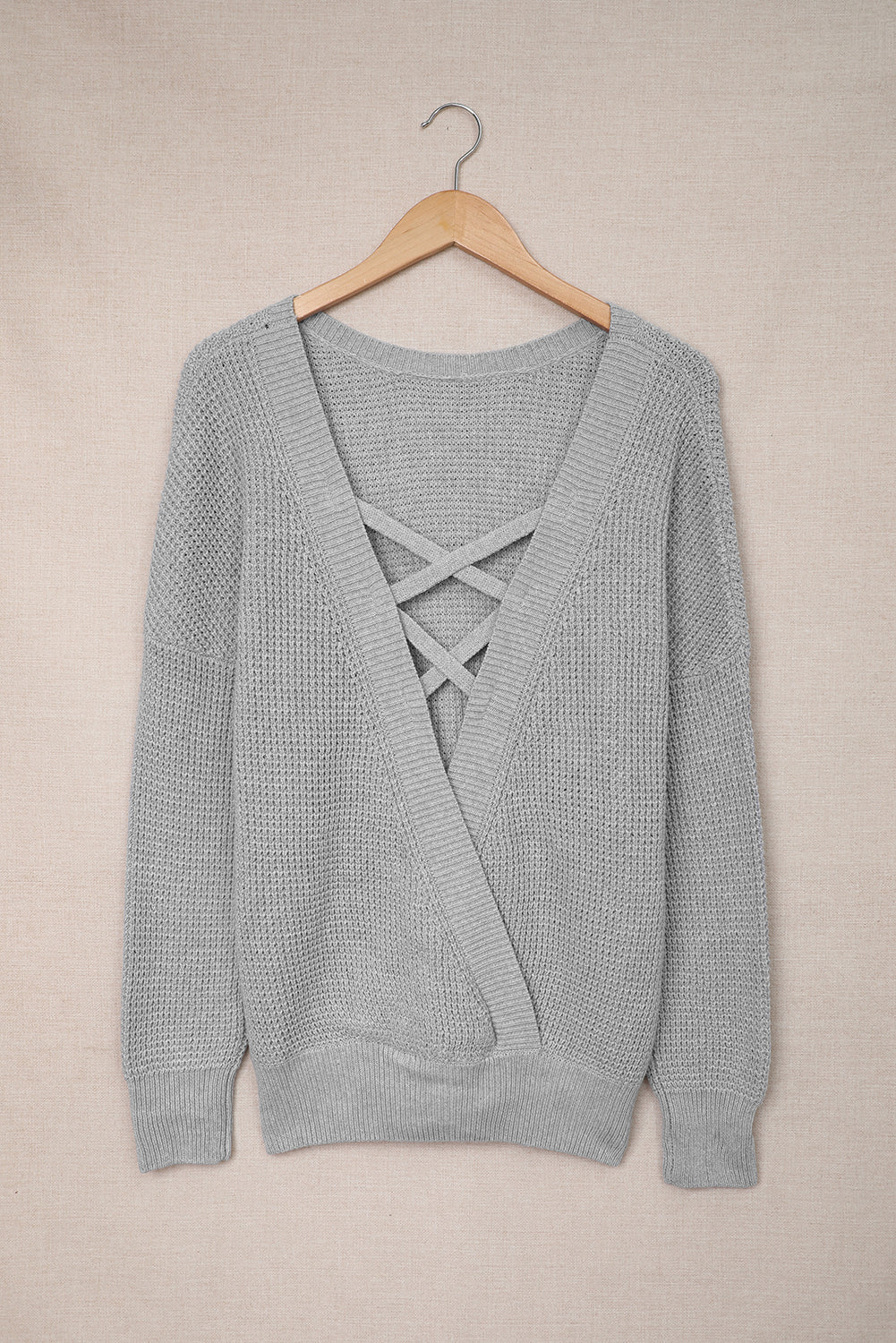 Gray Cross Back Hollow-out Sweater featuring a deep V hollow-out design and crisscross back, perfect for stylish layering.