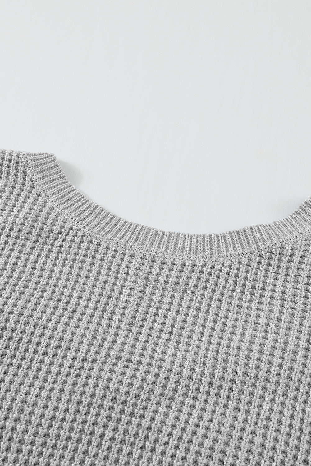 Gray Cross Back Hollow-out Sweater featuring a deep V hollow-out design and crisscross back, perfect for stylish layering.